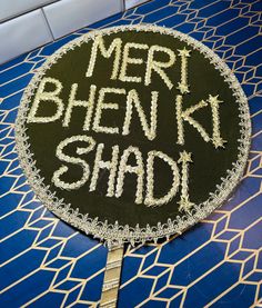 Shaadi Signs or Mehndi Signs! .  These signs are handcrafted  for Traditional Ceremonies. Can be used for Haldi, Mayoon, Dholki, Sangeet, Walima, Mehndi, or Shaadi events.  Shaadi Sign, Dholki Sign, Mehndi Sign.   Materials:  Silk Fabric  Gotta Lace  Gold Thread  Mehndi Decorations or Shaadi Decorations.  Signs that are pre-made are $19.99  Customs Signs are $39.99  Custom Signs take 3-4 weeks to process.  Width: 14 Inches Across  CONTACT SELLER IF YOU WOULD LIKE TO CUSTOMIZE YOUR COLORS and WORDS! NO RETURNS OR EXCHANGES. These are final sale. MUST CANCEL ORDER within 12 Hours. Dholki Props, Dholki Decor Home, Mehndi Props, Mehndi Decor At Home, Mehndi Decor Ideas, Dholki Sign, Mehndi Signs, Mehandi Night, Dholki Ideas