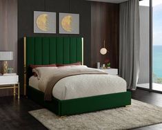 a bedroom with a green headboard and white bed in front of a large window