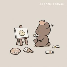 a teddy bear sitting in front of an easel