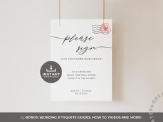 a white wedding card hanging from strings with the words, please sign our postcard guestbook