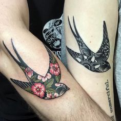 two people with matching tattoos on their arms, one has a bird and the other has flowers