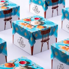 several boxes with different designs on them sitting side by side in the shape of chairs