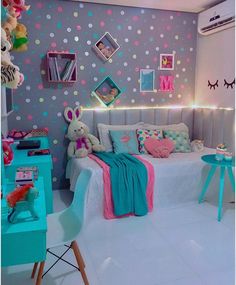 a bedroom decorated in pastel colors with polka dots on the walls and bedding