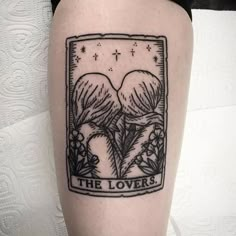 a tattoo on the leg of a woman with flowers and two birds above it that reads, the lovers