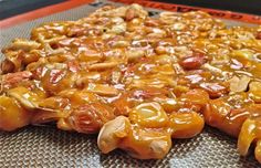 some kind of food that is sitting on a tray with oranges and nuts in it