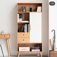 a book shelf with drawers and books on it