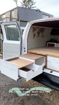 an open white truck with drawers in the back and side door opened to show wood flooring