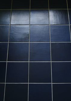 a black and white tiled bathroom floor with blue tiles