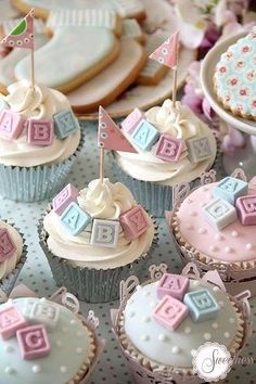 cupcakes decorated with baby blocks and flags