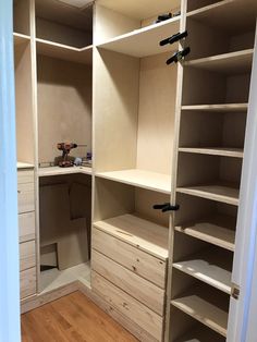 an empty walk in closet with shelves and drawers