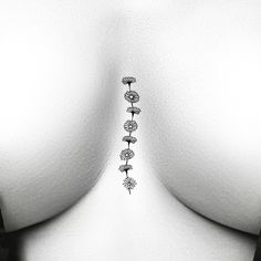 the back of a woman's breast with three small flowers on it, as well as two smaller ones