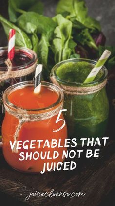 three jars filled with different types of juices and vegetables on top of a wooden table