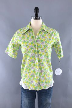 >> Shop our full collection! >> THISBLUEBIRD.COM Cute vintage 1960s to 1970s button down blouse in bright green and yellow floral print. In excellent condition. Poly cotton blend. Tag size 12-32. No stretch. Shown on XXS/XS dress form. Refer to measurements and leave room for ease of movement.   Bust - 38 inches Waist - 36 inches Hips - 38 inches Length - 25 inches Sleeves - 10.5 inches Shoulders - 15.5 inches Please review all photos in full.  SKU: 9006911   >> Shop our FULL COLLECTION << https://thisbluebird.com Subscribe to our newsletter for shop updates and coupon codes: https://thisbluebird.com/subscribe Looking for vintage men's clothing and accessories?  Check out our partner shop Fyve by Fyve! http://www.fyvebyfyve.etsy.com >> SHIPPING OUTSIDE THE USA << For all items being shippe