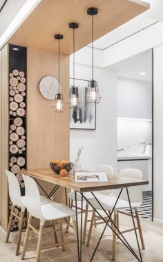 a dining room table with chairs and a clock on the wall