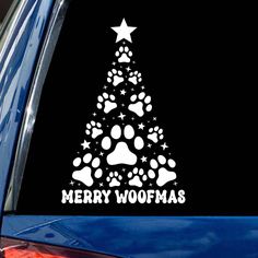 a christmas tree with paw prints and stars is shown on the side of a car