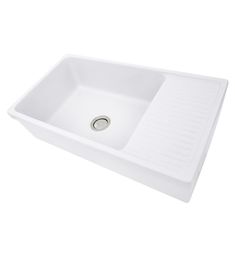 a white sink sitting on top of a counter next to a drain faucet