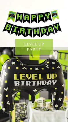 a black and green birthday party with an inflatable blow - up game controller