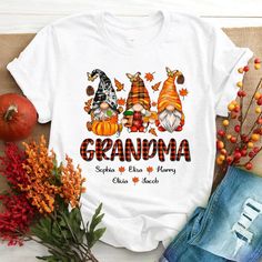 Fall Gnome Grandma And Kids CTH01 T-ShirtGreat as Birthday gifts or Holiday presents. This adorable item can be designed upon anyone's wish with any title.Please enter:1. Nickname. ie. Grandma, Nana, Mimi, ...etc.2. Kids' Names wanted on the shirt (Names separated by commas)All items are made to order.* Please be aware that the physical product's colors may differ slightly from the mockup. Brand: Gildan Classic unisex cut makes this easy to fit the body. Material: Heavyweight fabric Sport Grey A Shirt Names, Being A Grandma, Fall Gnomes, Fall Gnome, Make Your Own Shirt, Easy Backdrops, Holiday Presents, Pumpkin Coffee, Custom Tshirt