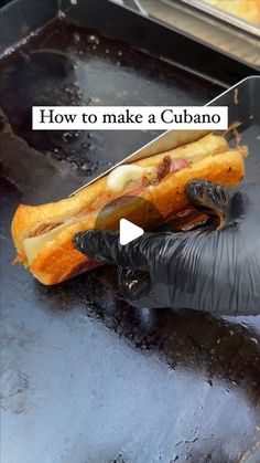 a person in black gloves is holding a hot dog on a grill with the words how to make a cubano