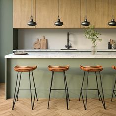 three stools in front of a kitchen island