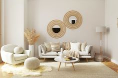 a living room filled with white furniture and pillows on top of a rug covered floor