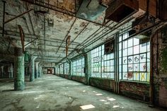 an abandoned building with lots of windows and graffiti on the walls