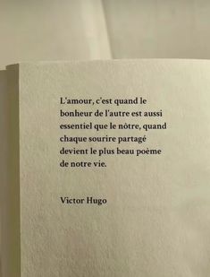 an open book with a poem written in french on the front and back pages,