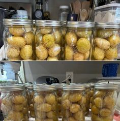 jars filled with potatoes sitting on top of a counter