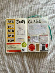 an open book with stickers on it sitting on top of a white bed sheet