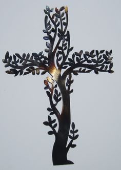 a metal cross with a tree on it