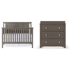 a baby crib and dresser with white sheets on the bottom, and brown drawers