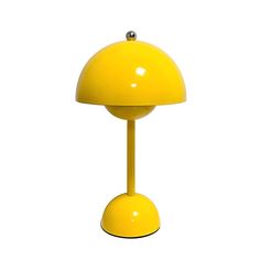 a yellow table lamp sitting on top of a white floor