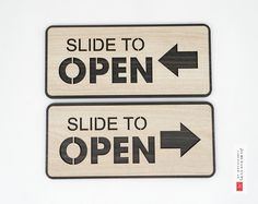 two wooden signs that say slide to open and side to open with an arrow pointing in the opposite direction