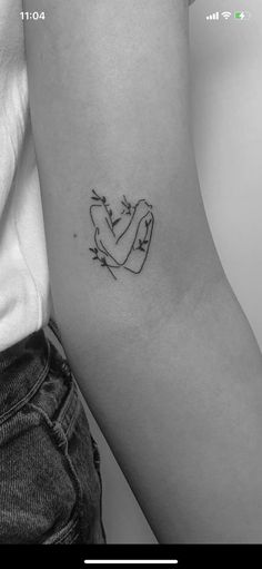 a woman's arm with a small tattoo on the left side of her arm