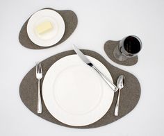 a white plate with silverware on top of it and a cup next to it