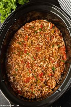 a crock pot filled with rice and vegetables