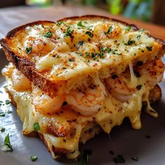 a grilled cheese and shrimp sandwich on a plate with parsley sprinkled on top