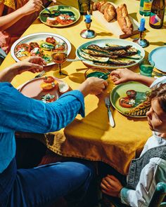 a group of people sitting around a table eating food