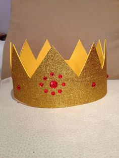 a gold crown sitting on top of a bed