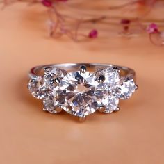 three stone engagement ring with diamonds on top