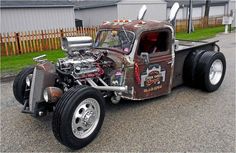 an old fashioned truck is parked on the street