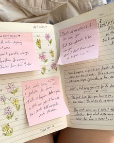 two notebooks with sticky notes attached to them, one is pink and the other has yellow flowers