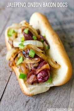 a close up of a hot dog on a bun with onions and relish in it