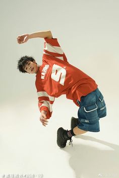 a young man is doing a trick on his skateboard in front of a white background