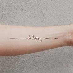 a woman's arm with the word be happy written in cursive font