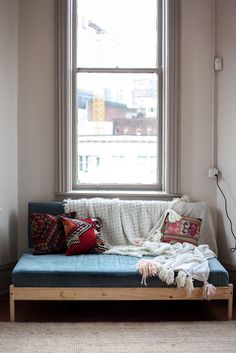 a living room with a couch, rug and window