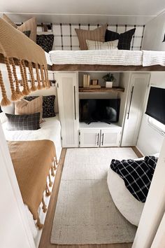 a small bedroom with bunk beds and white cupboards