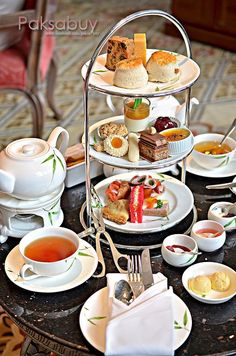 a table topped with plates and cups filled with different types of food on top of it