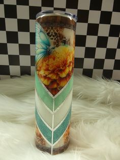 a colorful vase sitting on top of a white fur covered floor next to a black and white checkered wall