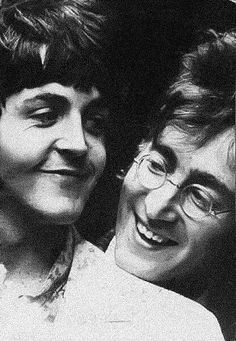 black and white photograph of two women smiling at the camera with their heads close to each other